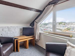 a living room with a television and a window at 2 Bed in Brixham 88019 in Brixham