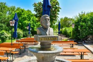 a statue of a man sitting in a fountain in a park at Hotel und Restaurant Nehrener Hof in Nehren +107 photos