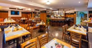 a restaurant with tables and chairs and a bar at Hotel und Restaurant Nehrener Hof in Nehren