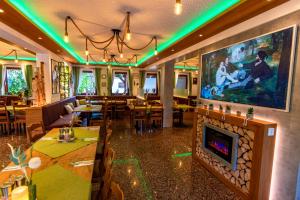 a restaurant with a fireplace and tables and chairs at Hotel und Restaurant Nehrener Hof in Nehren