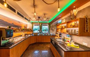 a restaurant with a bar with green lights at Hotel und Restaurant Nehrener Hof in Nehren