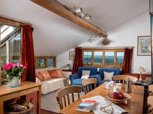 a living room with a table and a blue couch at 3 Bed in Dorstone BN070 in Hardwicke