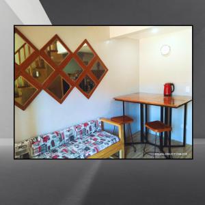 a room with a table and a couch and a table and chair at Belnidoloft apartment near airport unit1 in El Nido +15 photos
