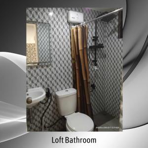 a bathroom with a toilet and a shower and a sink at Belnidoloft apartment near airport unit1 in El Nido
