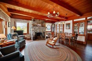 a living room with a fireplace and a dining room at Quiet Oceanfront Cottage with Dock in Boothbay Harbor