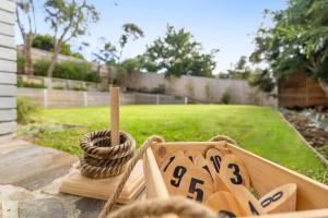 a group of wooden shoes sitting on a table in a yard at Backbeach House 1km to Beach in Blairgowrie
