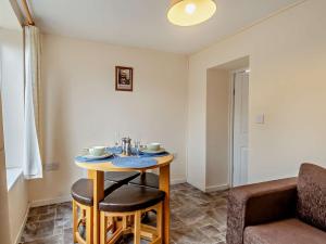 a small table in a room with a chair at 1 Bed in Wymondham 43278 in Wymondham +2 photos