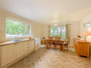 a kitchen with a table and a dining room at 3 Bed in Bude 89790 in Hollacombe