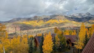 an autumn view of a mountain with trees and buildings at Riverside Condos B101 by AvantStay Condo Close To Downtown Town Park Ski Lift 8 in Telluride