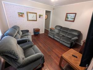 a living room with two couches and a brick wall at MinCo Properties WV, Carswell Hollow Overlook in Kimball