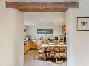 a kitchen with a wooden table and chairs at 2 Bed in Baslow PK801 in Barlow