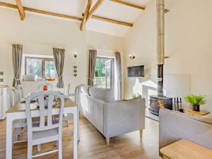 a living room with a table and a fireplace at 3 Bed in Bude BBARN in Sutcombe