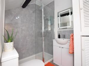 a bathroom with a shower and a toilet and a sink at 3 Bed in Nefyn 55571 in Nefyn +22 photos