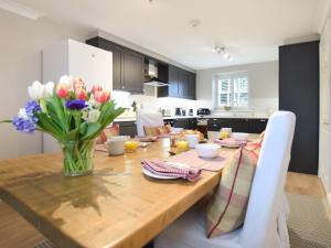 a kitchen with a wooden table with flowers on it at 2 Bed in York G0096 in Little Ouseburn