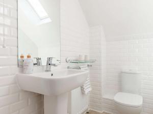 a white bathroom with a sink and a toilet at 2 Bed in York G0096 in Little Ouseburn +14 photos