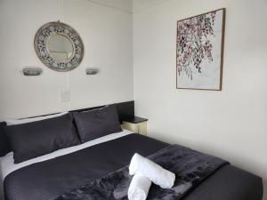 a bedroom with a bed with a mirror on the wall at Seaspray Caravan Park in Seaspray