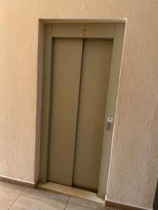 a door with a number on it in a wall at 比绍民宿 in Bissau +2 photos