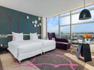 Ένα ή περισσότερα κρεβάτια σε δωμάτιο στο Pullman Saigon Centre