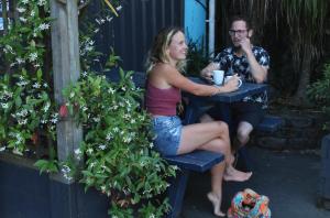 a man and a woman sitting on a bench at Stars Hostel in Auckland