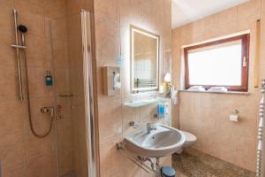 a bathroom with a shower and a sink and a toilet at Hotel und Restaurant Nehrener Hof in Nehren +85 photos