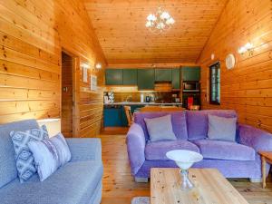 a living room with two purple couches and a table at 3 Bed in Clovelly 00374 in Clovelly