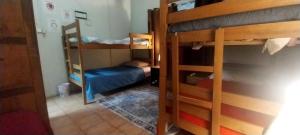 a room with two bunk beds and a small bed at Patagonia Mágica in Punta Arenas +5 photos