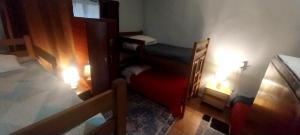 a room with two bunk beds and a red chair at Patagonia Mágica in Punta Arenas