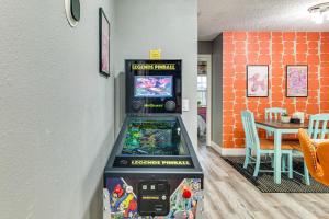 a video game machine in a room with a table at 9 Mi to Legoland Family Gem with Games Galore! in Eagle Lake
