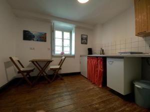 a kitchen with two chairs and a table in it at Hof Ohnesorge in Teutschenthal +8 photos