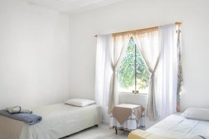 a bedroom with two beds and a window at Casa Eva, rústica y cálida familiar in Asuncion +35 photos