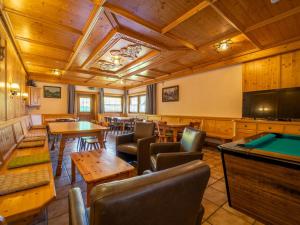 a large room with tables and a pool table at Ferienhaus Almhof in Gerlosberg
