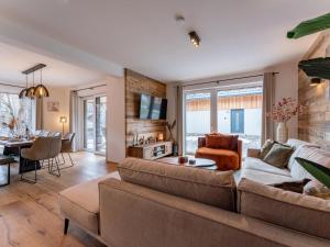 a living room with a couch and a table at Mountain Chalet Arnica in Sankt Lorenzen ob Murau