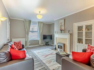 a living room with a couch and a fireplace at 2 Bed in Wooler 92074 in Wooler