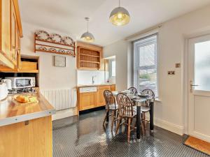 a kitchen with a table and chairs in a room at 2 Bed in Wooler 92074 in Wooler +15 photos