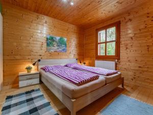 Un dormitorio con una cama en una cabaña de madera. en Sternenchalet, en Liebenfels
