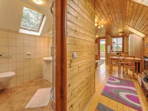 a bathroom with a toilet and a dining room at Karawankenpanorama in Liebenfels +30 photos