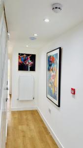 a white room with paintings on the wall at DSK Residencia in Maidstone