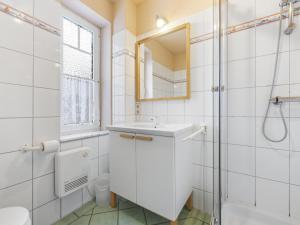 a bathroom with a sink and a shower and a mirror at Nordlicht - Strandkorb EG in Timmendorf +26 photos