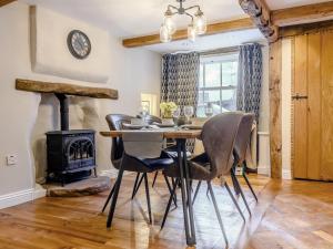 a dining room with a table and a wood stove at 2 Bed in Ullswater 87349 in Penrith