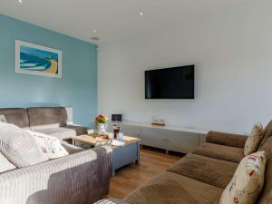 a living room with two couches and a flat screen tv at 4 Bed in Newquay 90325 in Newquay