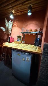 a kitchen with a counter top and a dishwasher at Hospedaje Maité in Santa María