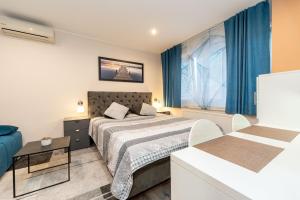 a hotel room with a bed and a window at Apartments and rooms with a swimming pool Sukosan, Zadar - 5906 in Sukošan +55 photos