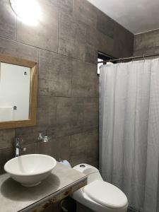 a bathroom with a sink and a toilet and a shower at Costa Ayala - Bungalow 3 with 1ks bed and 3 sofas in Los Ayala