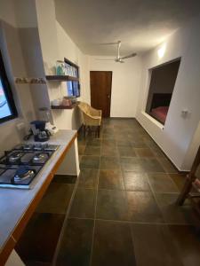 a kitchen with a stove and a counter top at Costa Ayala - Bungalow 3 with 1ks bed and 3 sofas in Los Ayala +12 photos