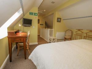 En eller flere senge i et værelse på Wash House Cottage