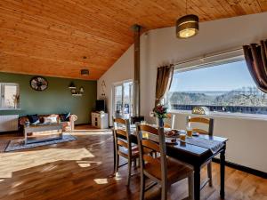 a dining room with a table and a large window at 2 Bed in Sidmouth 91118 in Ottery Saint Mary