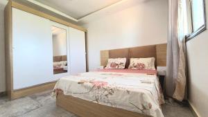 a bedroom with a bed and a large mirror at Villa Toubab Dialaw in Toubab Dialaw +24 photos