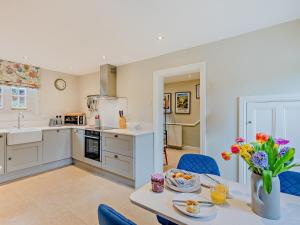 a kitchen and dining room with a table and chairs at 2 Bed in Pencombe 27478 in Pencombe +12 photos