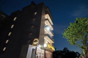 a tall building with a sign on it at night at Super Townhouse OAK VS Shivanya in Lucknow