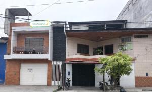 a building with a sign on the front of it at Alojamiento CASA LUNA in Iquitos